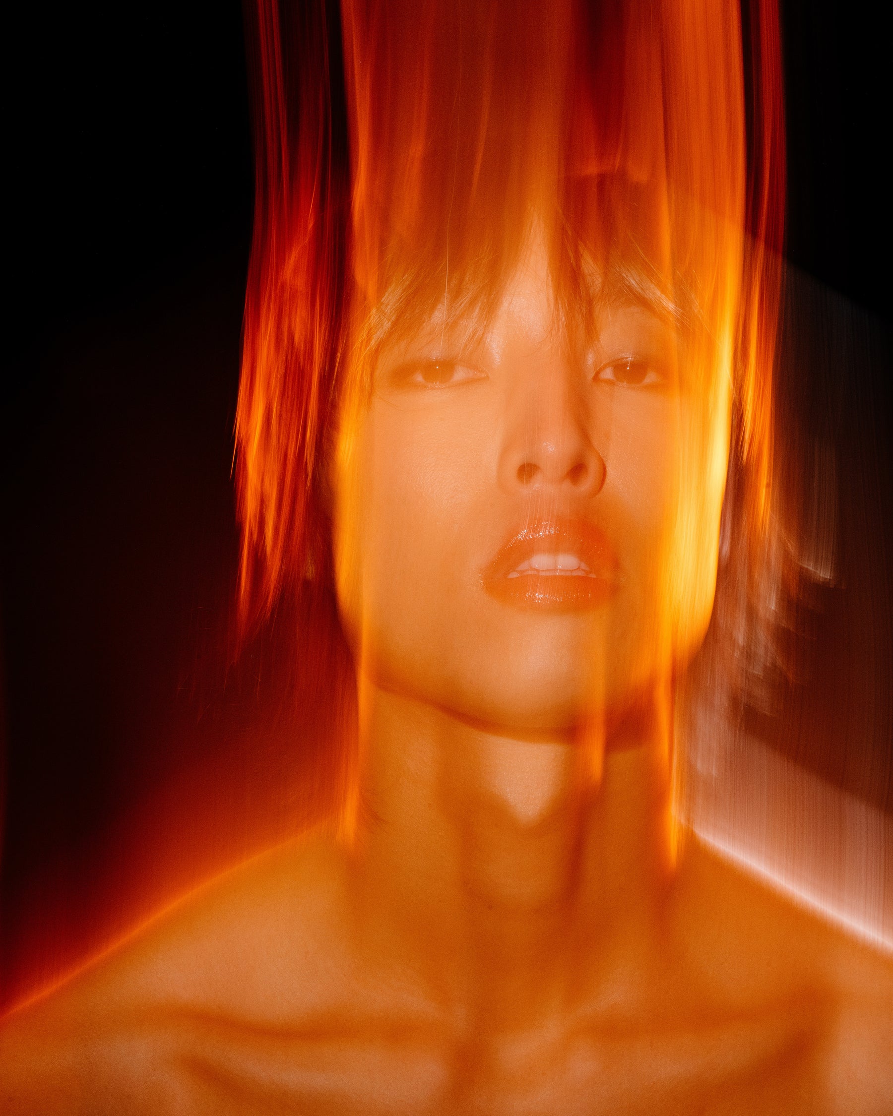 A man wearing lip oil and eyeliner.